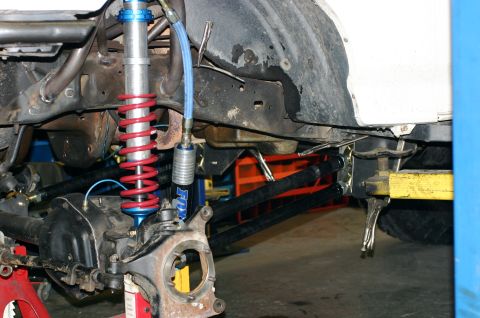1995 Ford Bronco - Custom suspension components are visible on a vehicle undergoing modification or repair.