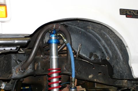 1995 Ford Bronco - Custom suspension modification shown in the wheel well of a vehicle.