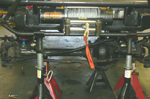 1995 Ford Bronco - Close-up view of a vehicle's undercarriage, highlighting a winch and suspension system.