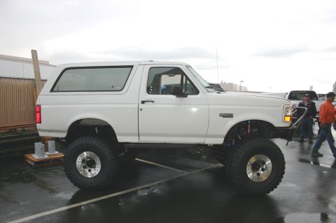 1995 Ford Bronco - This modified Ford Bronco features a lifted suspension and oversized tires, indicating a model year prior to 1997.