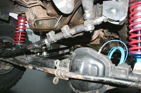 1995 Ford Bronco - The image shows the front axle and suspension system of a vehicle, coilovers and steering components.