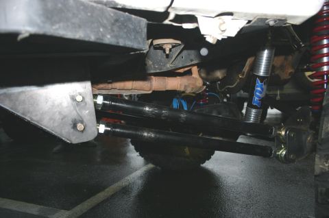 1995 Ford Bronco - The vehicle's undercarriage shows aftermarket suspension components, including Fox shocks.