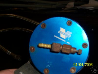 1994 Ford Probe - A blue fuel pressure regulator with a white logo and brass fittings is shown close-up.