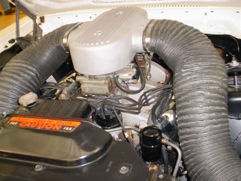 1972 Ford Ranchero - Close-up of a 1972 Ford Ranchero's engine bay, highlighting the custom air intake system and a prominent caution label.