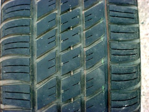 1973 Ford Ranchero - A detailed view of a tire's tread pattern, showing the arrangement of blocks and grooves.