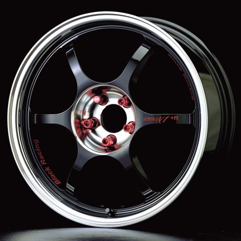 1993 Ford Probe - A close-up view of a black racing wheel red lug nuts and a polished silver lip.