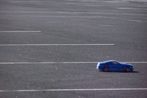 1994 Ford Bronco - A blue toy car is parked on a lot with painted lines.