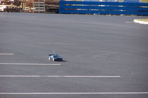1994 Ford Bronco - A remote control car is seen on an asphalt surface with white lines.