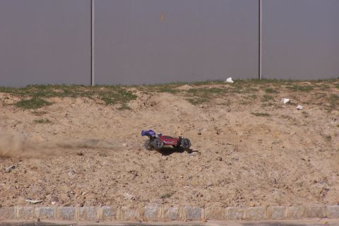 1994 Ford Bronco - RC buggy races across a dusty terrain.