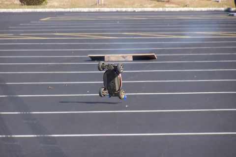 1994 Ford Bronco - Remote control car airborne after hitting a ramp in an empty parking lot.