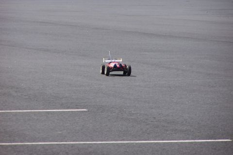 1994 Ford Bronco - A remote control car is seen from the front on a paved surface marked with white lines.