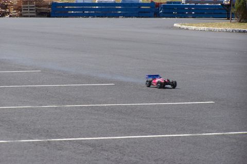 1994 Ford Bronco - Remote control car driving on a paved lot with white lines.