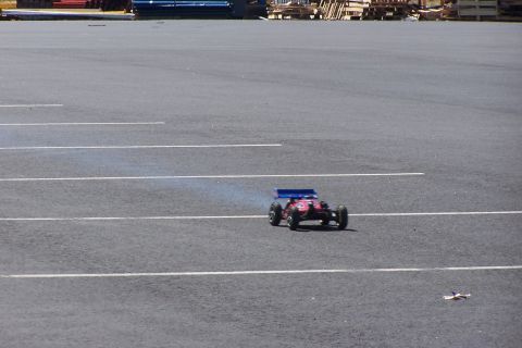 1994 Ford Bronco - A remote-controlled car drives on a paved surface, leaving a trail of smoke.