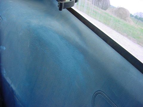 1978 Ford Mustang II - Interior shot of a vehicle's dashboard with a view of the countryside and hay bales.