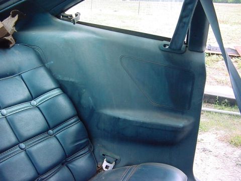 1978 Ford Mustang II - Interior view of a car's rear passenger side, showing seat and door panel details.