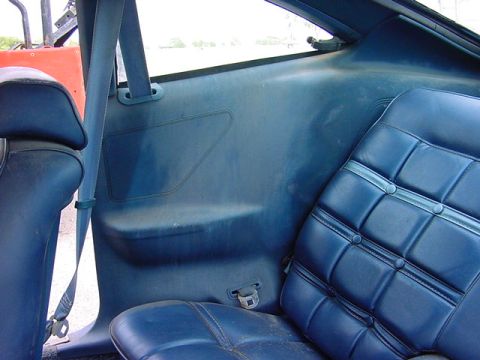 1978 Ford Mustang II - The interior of a 1978 Ford Mustang II features blue vinyl seats and matching side panels.