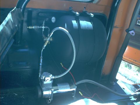 1978 Ford Bronco - An air compressor and tank are visible mounted inside the vehicle's interior.