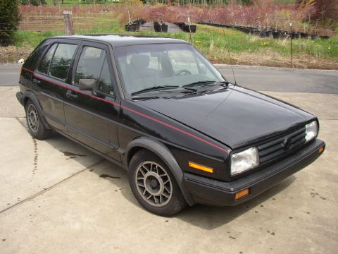 1987 Volkswagen Golf - This black Volkswagen Golf hatchback is shown from a 3/4 front angle.