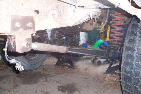1987 Ford Bronco - Undercarriage view of a vehicle's suspension system, possibly undergoing maintenance or modification.