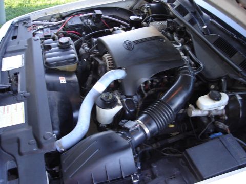 2000 Ford Crown Victoria - View of the engine bay, showing the air intake system and coolant reservoir.
