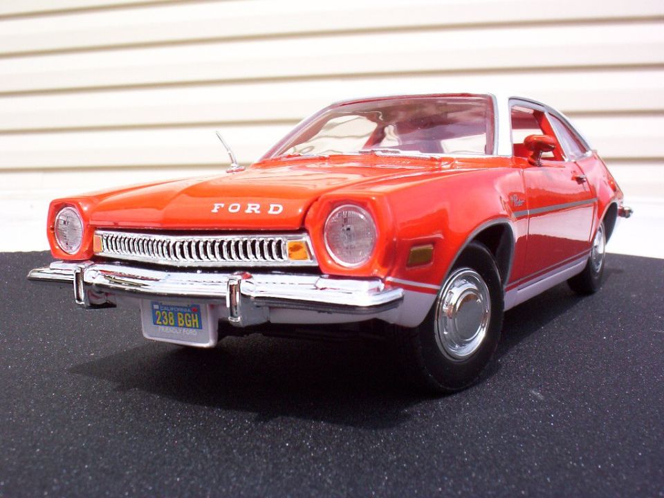 Front three-quarter of orange Ford Pinto model with FORD on hood and California plate