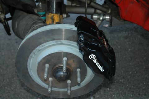 1993 Ford Mustang - Close-up view of a black Brembo brake caliper and rotor assembly.