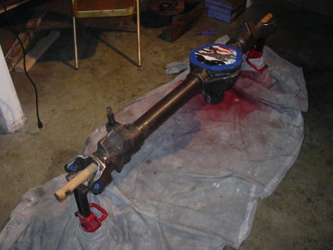 1991 Ford Bronco - A differential axle assembly is shown on a tarp, with a red jack providing support.