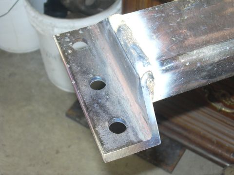 1991 Ford Bronco - Close-up view of a fabricated metal bracket, showing drilled holes and welded seams.