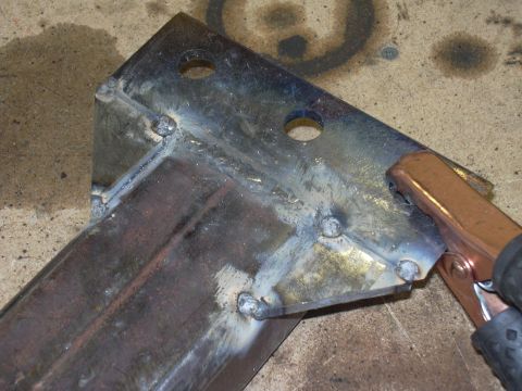 1991 Ford Bronco - A close-up view of a welded metal bracket, showing its construction and a connected clamp.