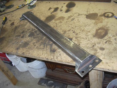 1991 Ford Bronco - Fabricated metal bracket on a workbench, likely for automotive repair or modification.
