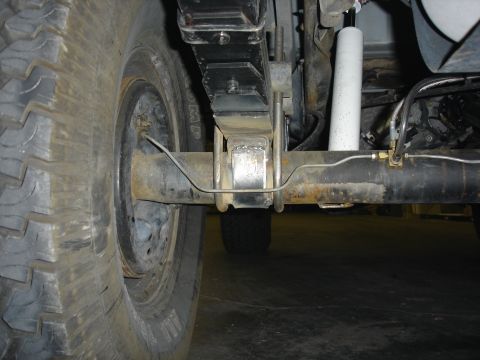 1996 Ford Bronco - Close-up view of the rear axle and suspension system on a 1996 Ford Bronco, highlighting the leaf springs and shock absorber.