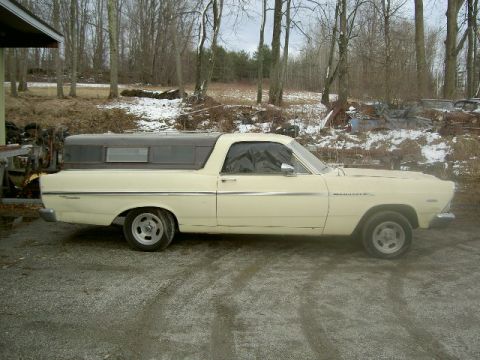 1967 Ford Ranchero - A 1967 Ford Ranchero pickup truck with a camper shell is parked outdoors in a rural setting.