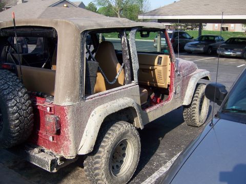 1998 Jeep TJ - This 1998 Jeep TJ is shown with its soft top removed, revealing the interior and roll cage.