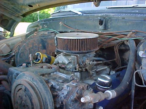 1978 Ford Bronco - The engine bay of a 1978 Ford Bronco, showing the carburetor and air filter assembly.