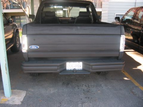 1991 Ford Bronco - Rear view of a 1991 Ford Bronco, showing the tailgate with Ford emblem and license plate.