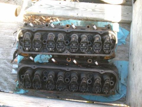 1986 Ford Bronco - Pair of engine cylinder heads, likely from a V8 engine, shown outdoors.