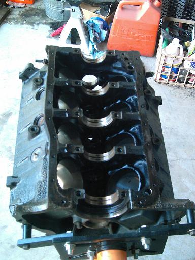 1986 Ford Bronco - Engine block shown on a stand, with garage items in the background.