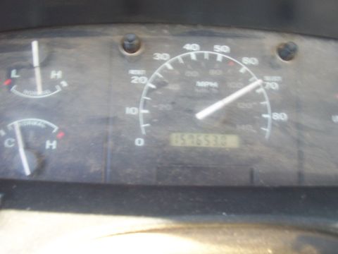 1994 Ford F-150 - Close-up of a dusty Ford truck instrument cluster with the needle resting near 70 MPH on the 80 MPH analog speedometer and a mechanical odo…