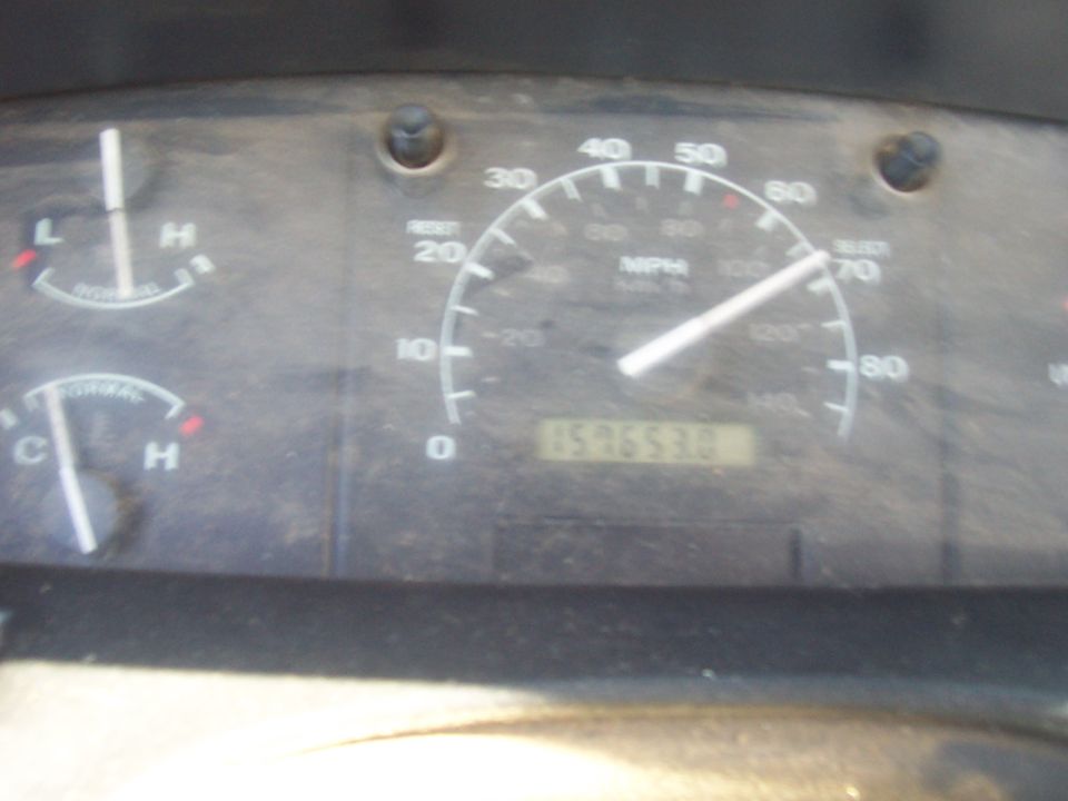 Dusty truck gauge cluster with 80 MPH speedometer and odometer near 159,663 miles