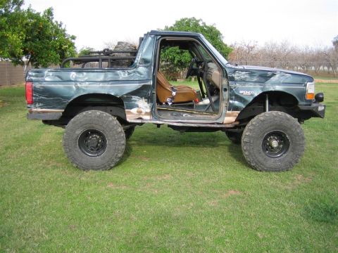 1994 Ford Bronco - This modified 1994 Ford Bronco shows significant body damage and off-road enhancements.