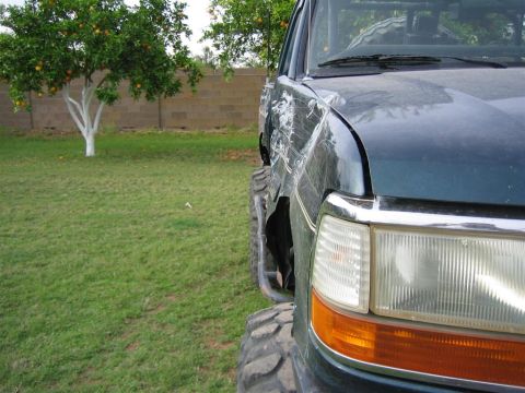 1994 Ford Bronco - This 1994 Ford Bronco shows significant body damage to its front quarter panel.