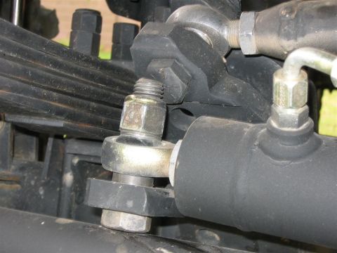 1994 Ford Bronco - Detailed view of vehicle suspension system components, including leaf springs and a hydraulic cylinder.