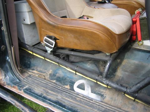 1994 Ford Bronco - Interior view of a vehicle equipped with racing seats and a roll cage.