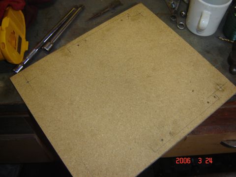 1993 Ford Bronco - Workbench with a piece of particle board marked for cutting, along with various tools and a mug.