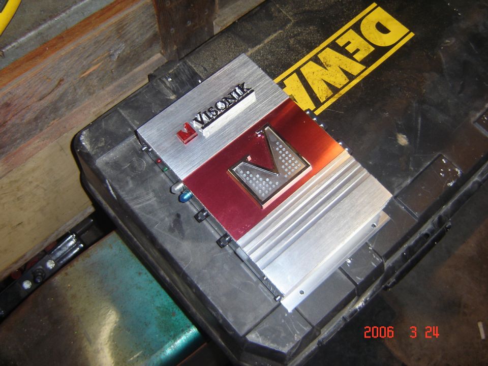 Visonik car amplifier on a black case with a yellow DeWalt logo