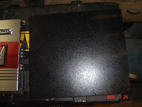 1993 Ford Bronco - Audio amplifier and a black textured panel are visible in the image.