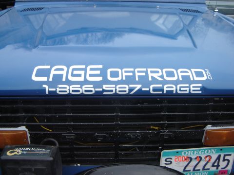 1993 Ford Bronco - This blue SUV features the text CAGE OFFROAD and a phone number on its hood.