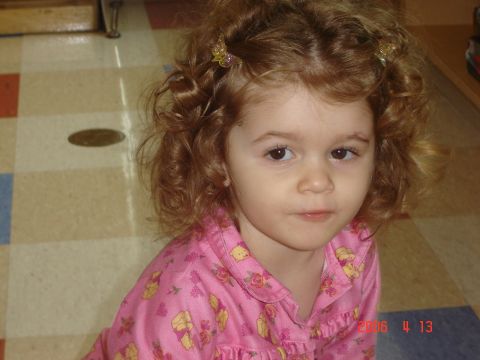 1993 Ford Bronco - A young child with curly hair wears pink pajamas adorned with floral patterns.