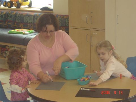 1993 Ford Bronco - A woman and two children are engaged in a craft activity at a table.