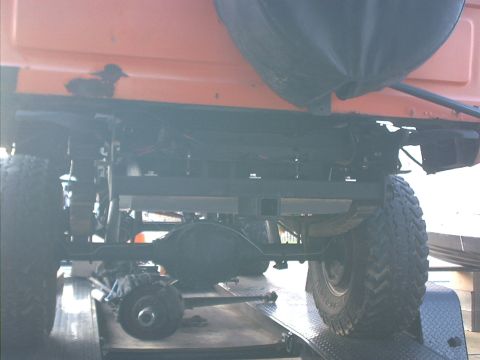 1978 Ford Bronco - The rear axle and suspension components of a vehicle are visible from below.